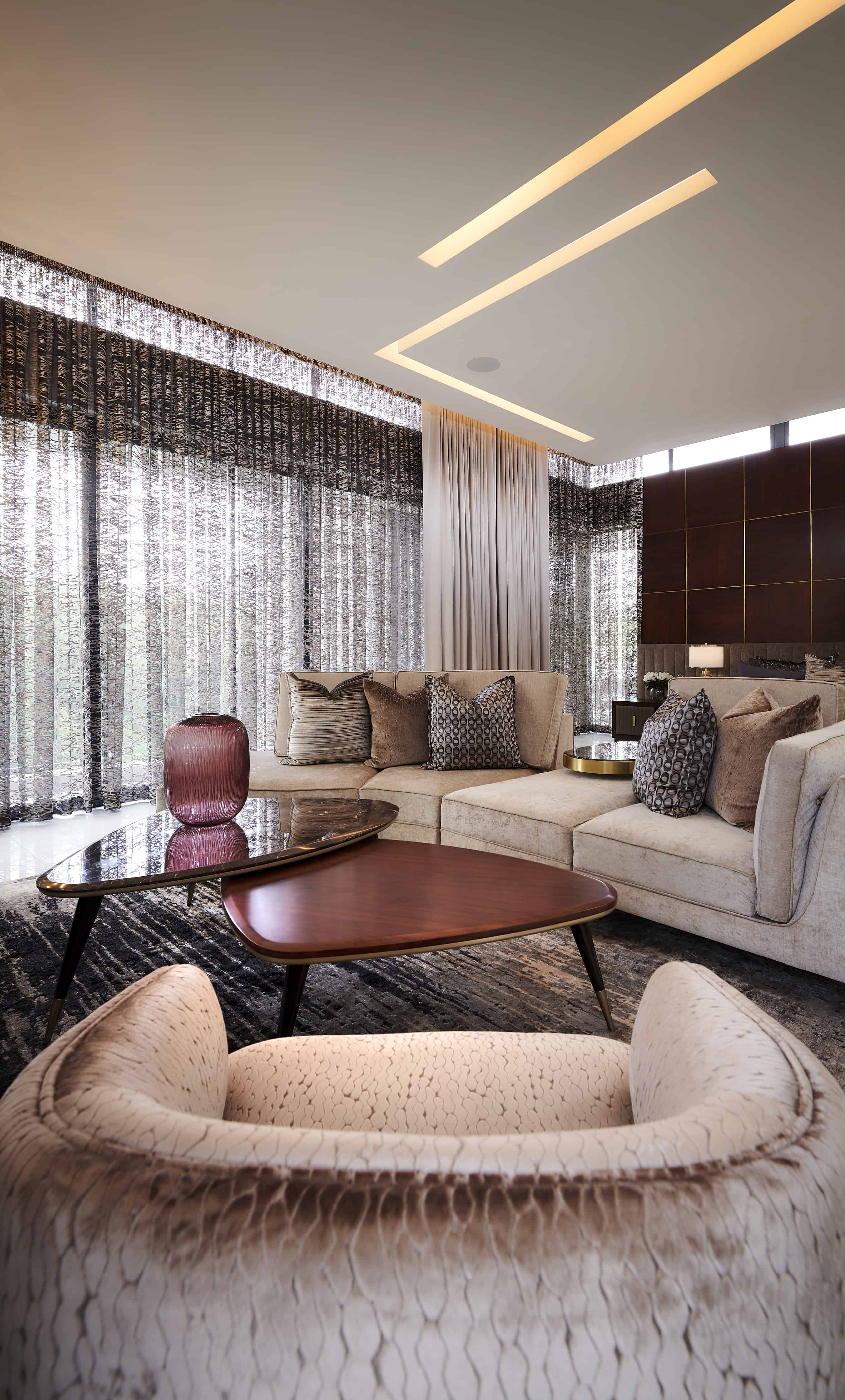 Luxurious living room featuring a sectional sofa, elegant coffee table and soft lighting by Interior Designer Johannesburg.