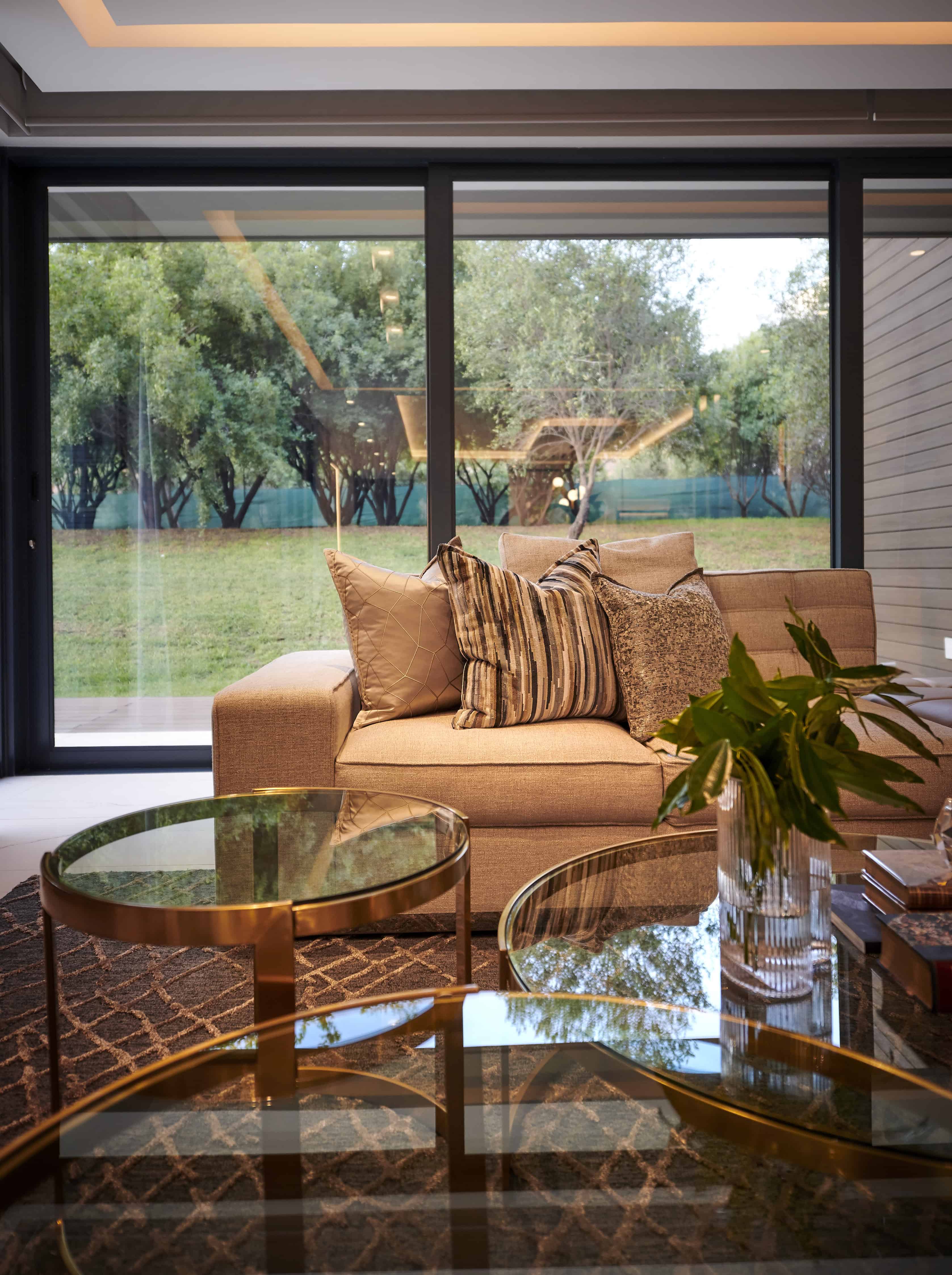 Lounge with garden views, rattan furniture and neutral palette styled by Interior Designer Johannesburg.