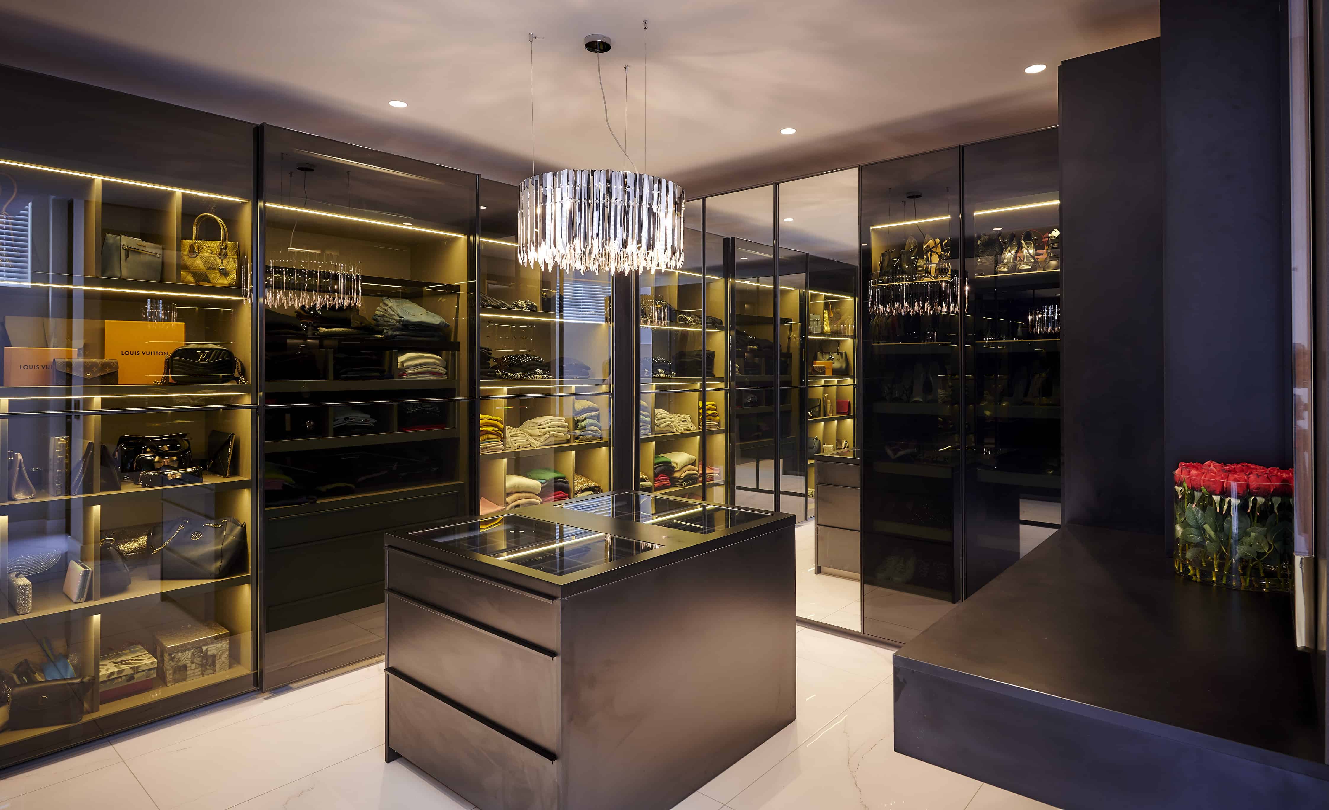 Sleek walk‑in closet with glass display and modern shelving created by Interior Designer Johannesburg.