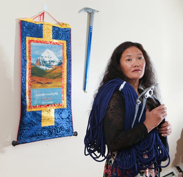 Lhakpa at home in West Hartford, Conn. She is holding her climbing gear.