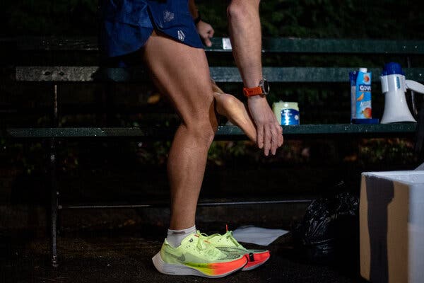 Applying petroleum jelly to his feet before putting on his shoes.