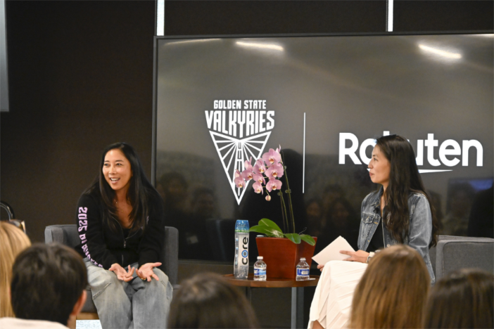 A group of women sitting in front of a large screenAI-generated content may be incorrect.