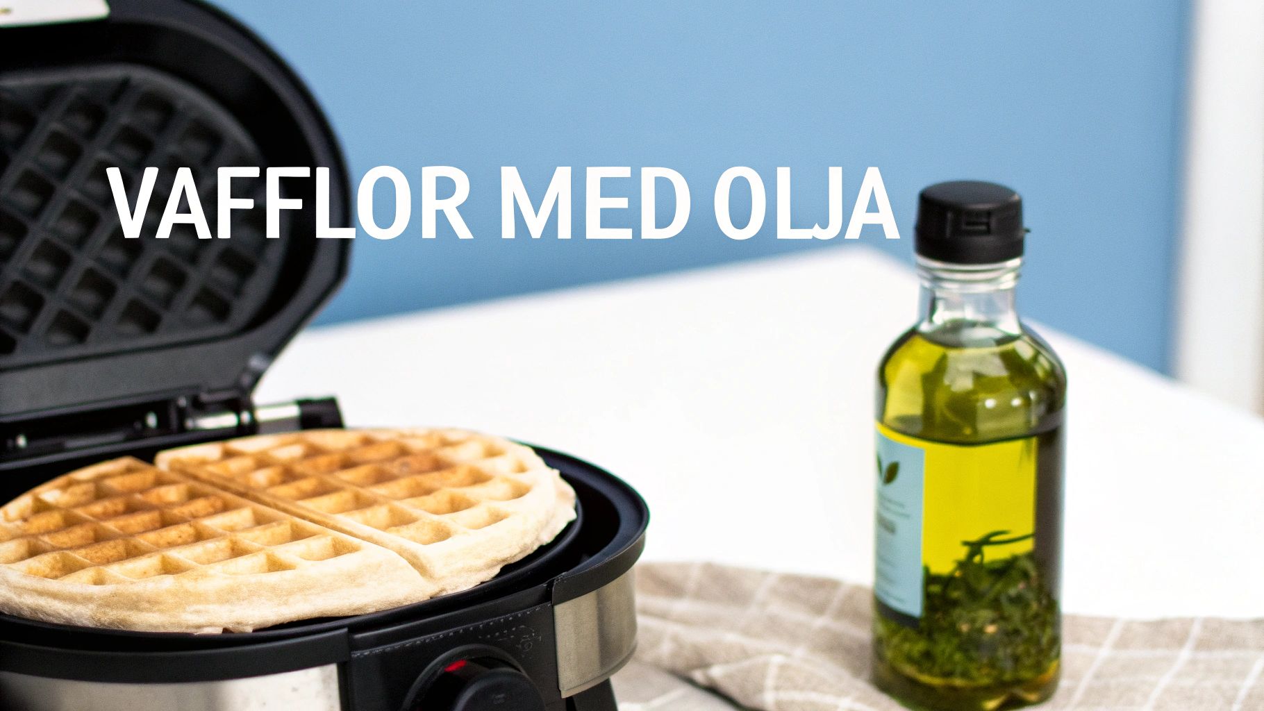 En nygräddad våffla ligger i ett våffeljärn med en flaska olja bredvid på en kökshandduk.