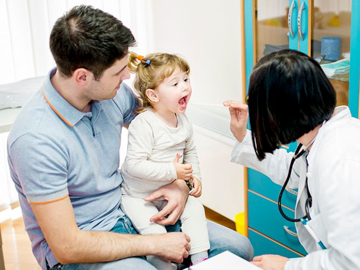 Parent holding baby after successful frenectomy with a sense of relief