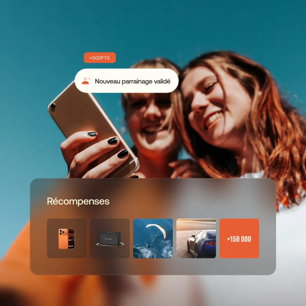 Two smiling women looking at a smartphone with a notification showing '+500PTS Nouveau parrainage validé' and a rewards panel featuring images of a smartphone, speaker, paraglider, sports car, and a points counter '+150 000'.