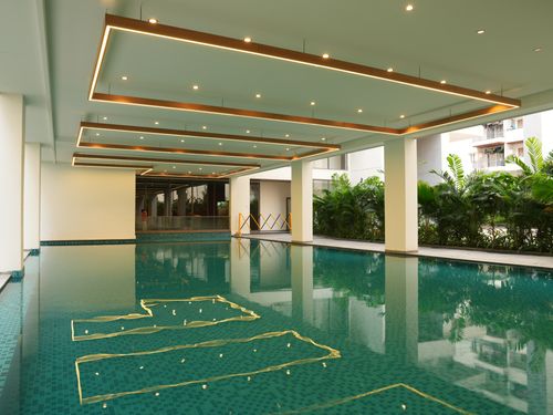 Indoor swimming pool at EIPL Cornerstone with modern design and ambient lighting.