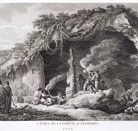 Black and white engraving of the entrance to Antiparos cave showing people exploring inside with torches and smoke around.