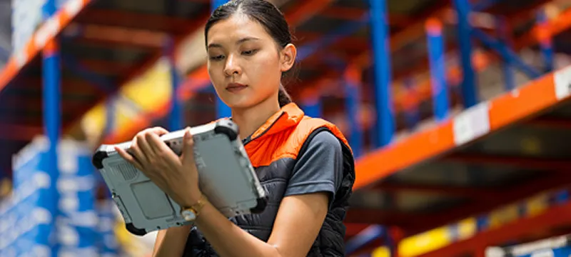 warehouse supervisor using industrial tablet