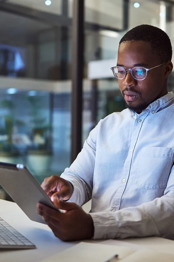 businessman analyzing data on a tablet in his office