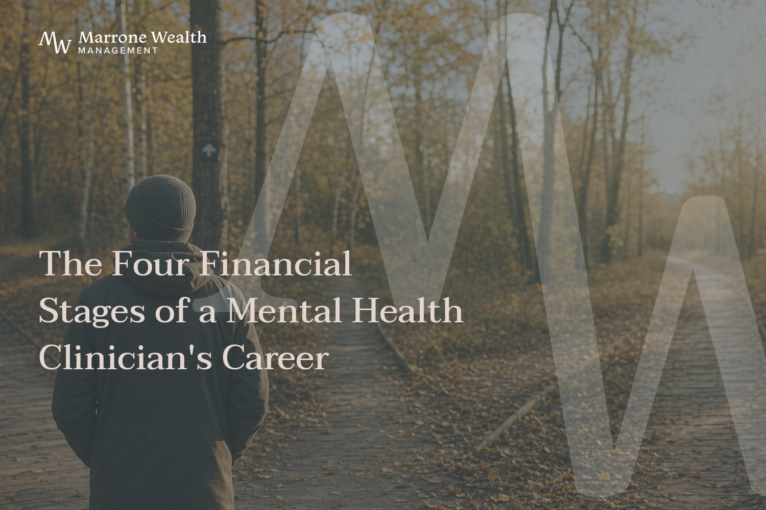 A person in a beanie and jacket walking on a forest trail at golden hour where the path forks in two directions, representing the four career stages of a mental health clinician.
