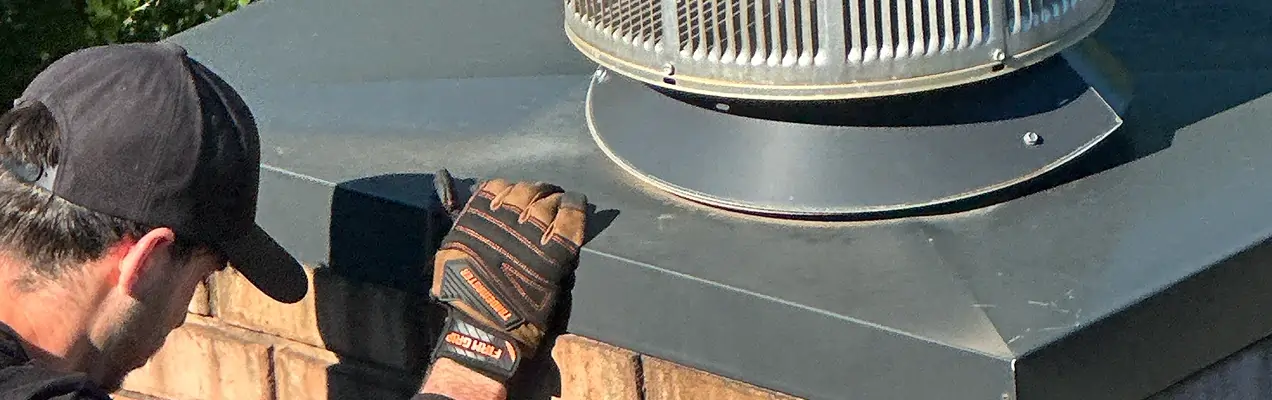 Professional chimney inspection performed by a certified technician on a residential roof