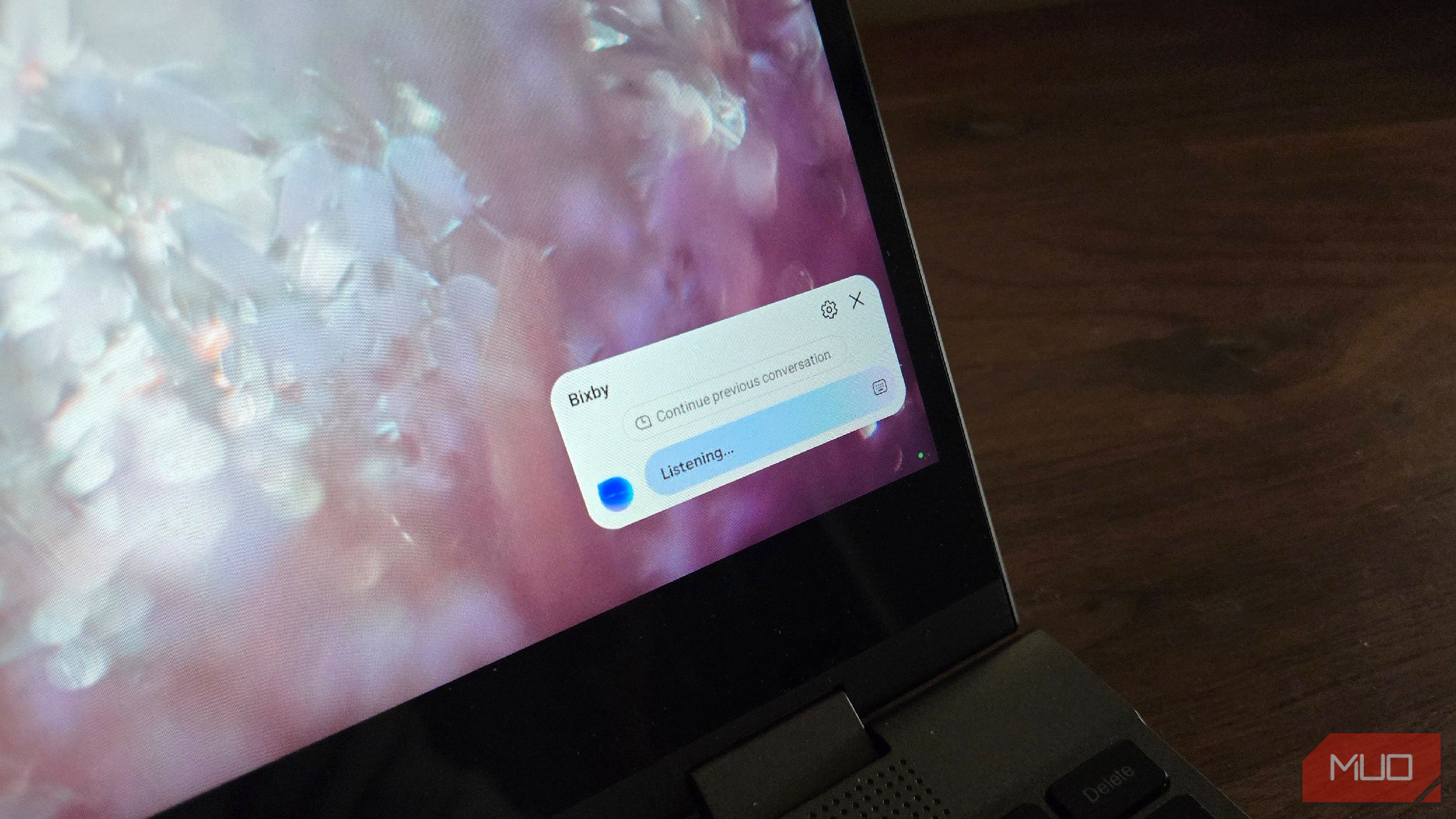 Person using voice assistant at computer workstation