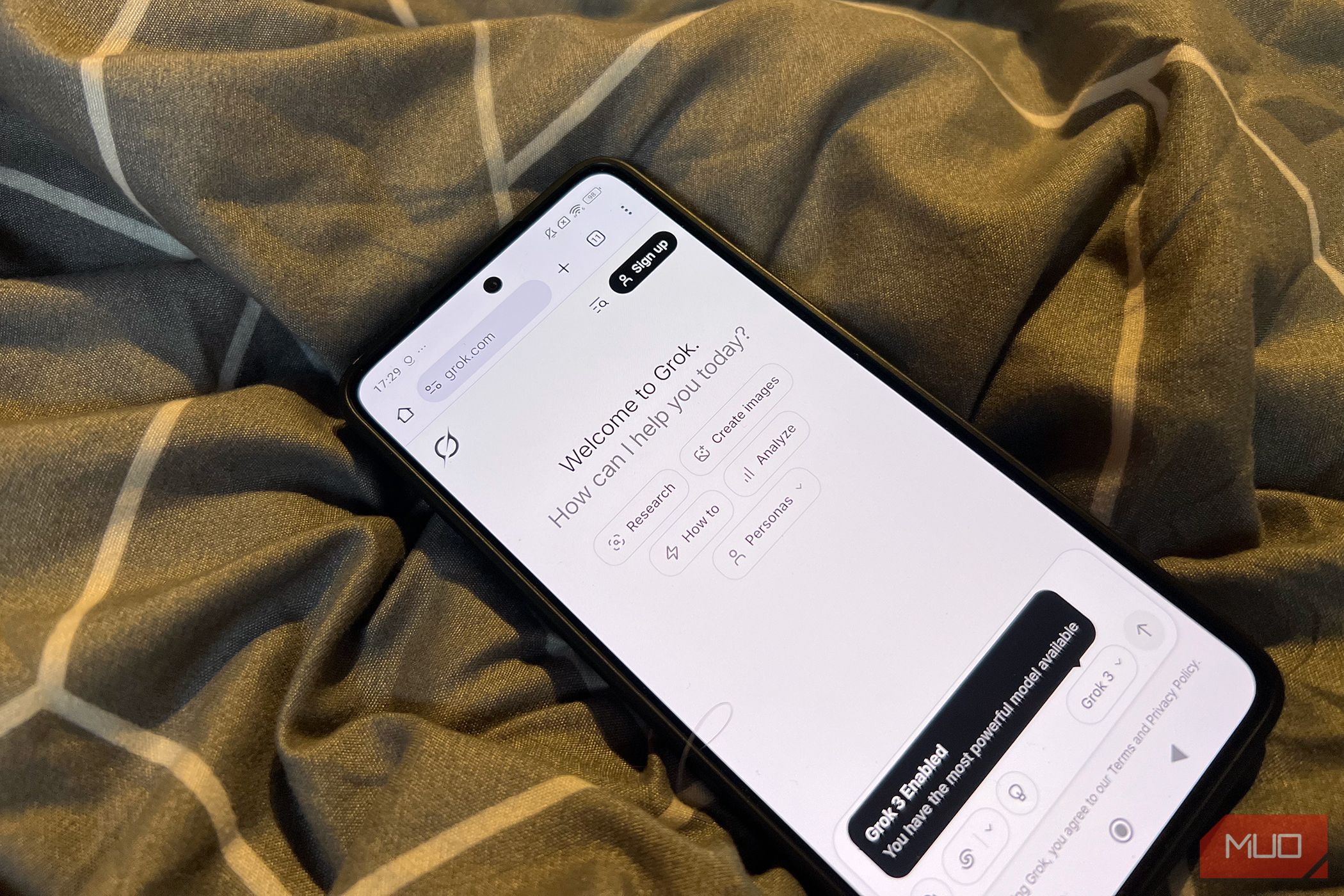 A mobile phone with the Grok Studio workspace open.