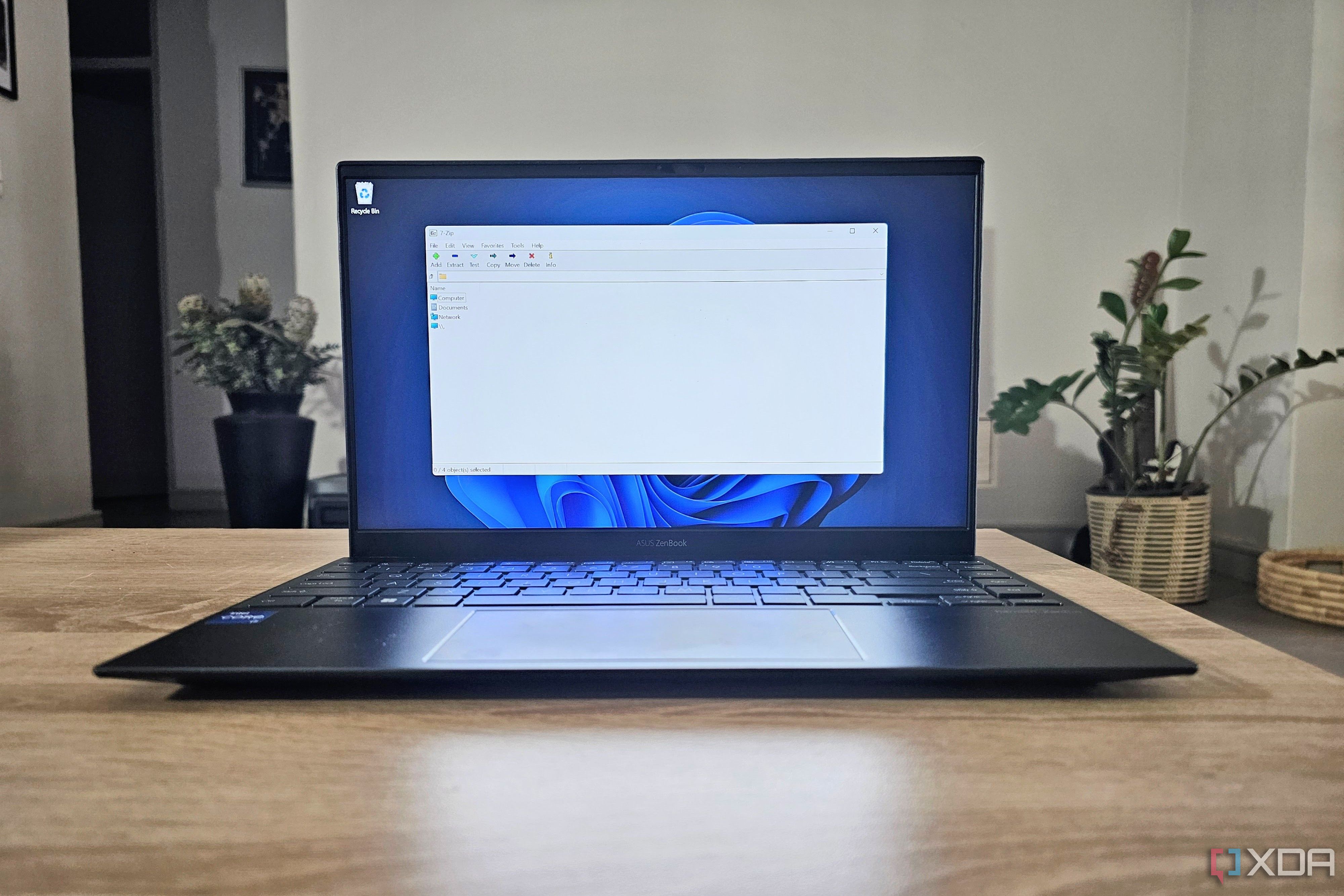 A laptop running the open-source program 7-Zip.