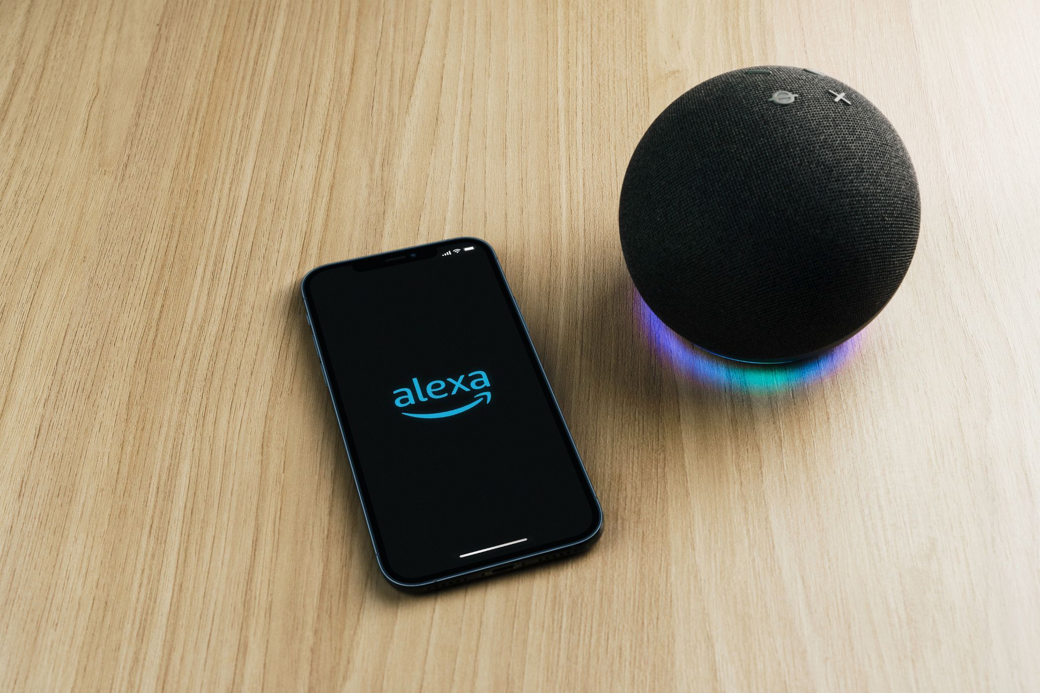 Alexa app on phone next to Echo speaker