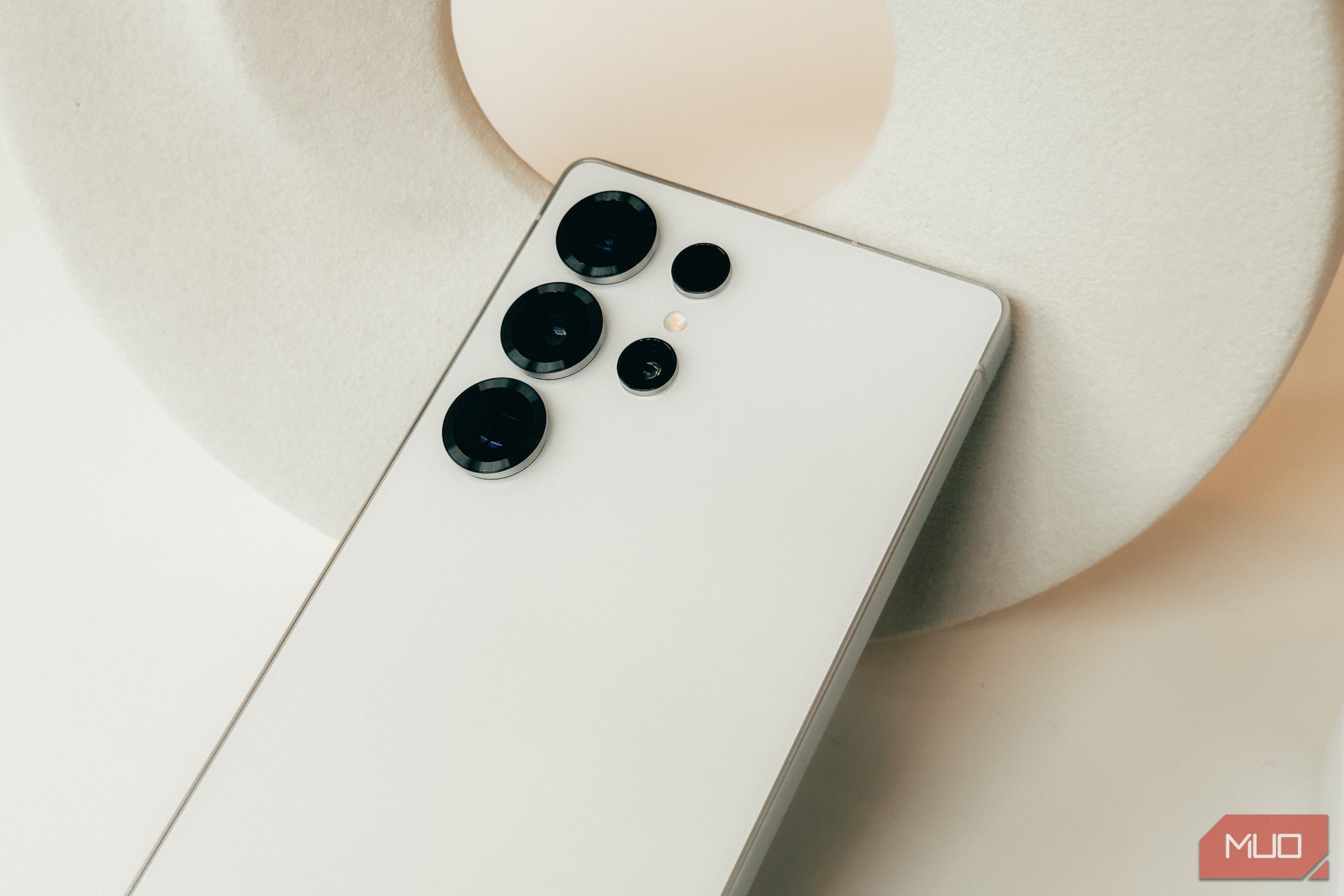 Closeup of Samsung Galaxy S25 in white showing camera features.