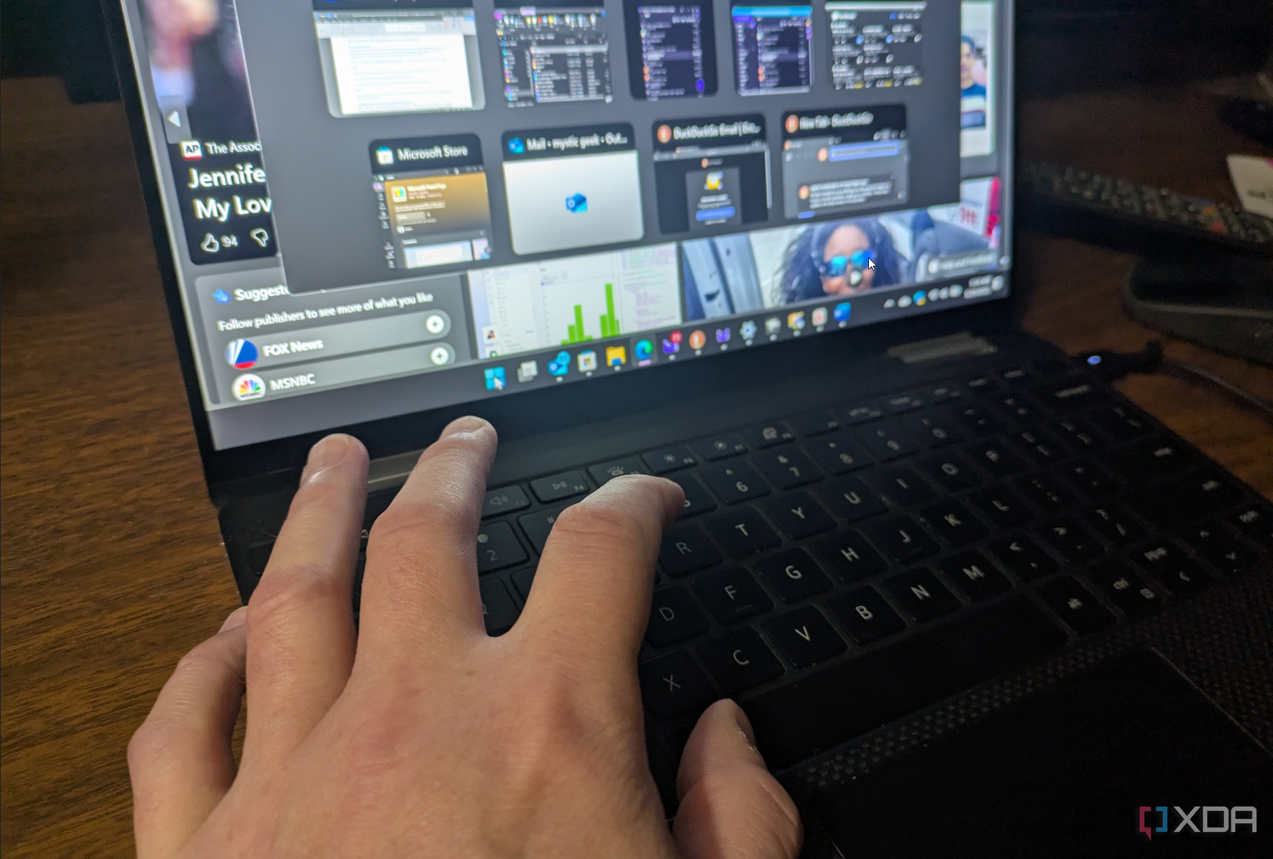 Hands typing keyboard shortcuts on a laptop.