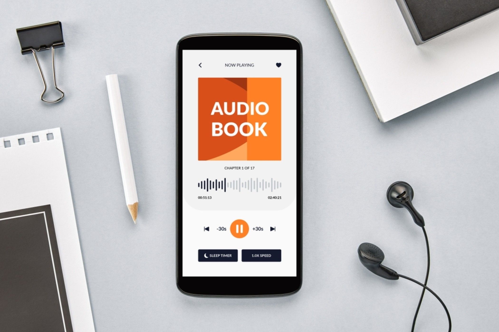 Smartphone playing audiobook on a desk