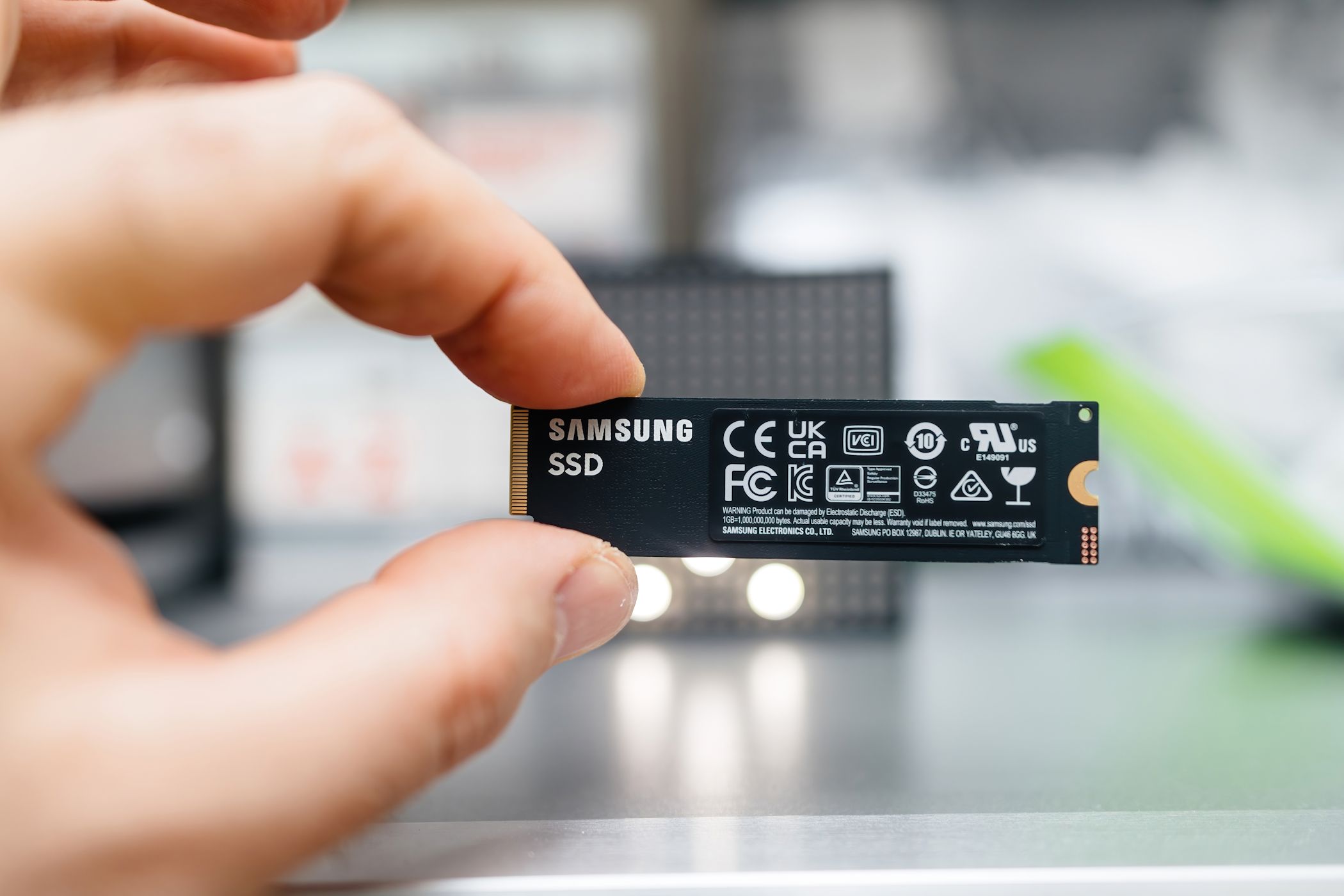 Person holding NVMe SSD with fingertips