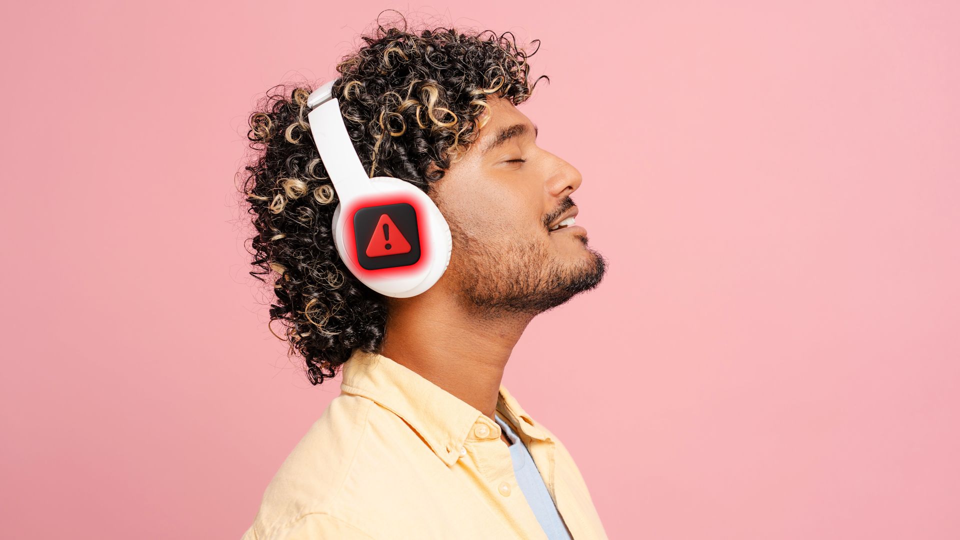 Man using Bluetooth headphones with digital warning sign