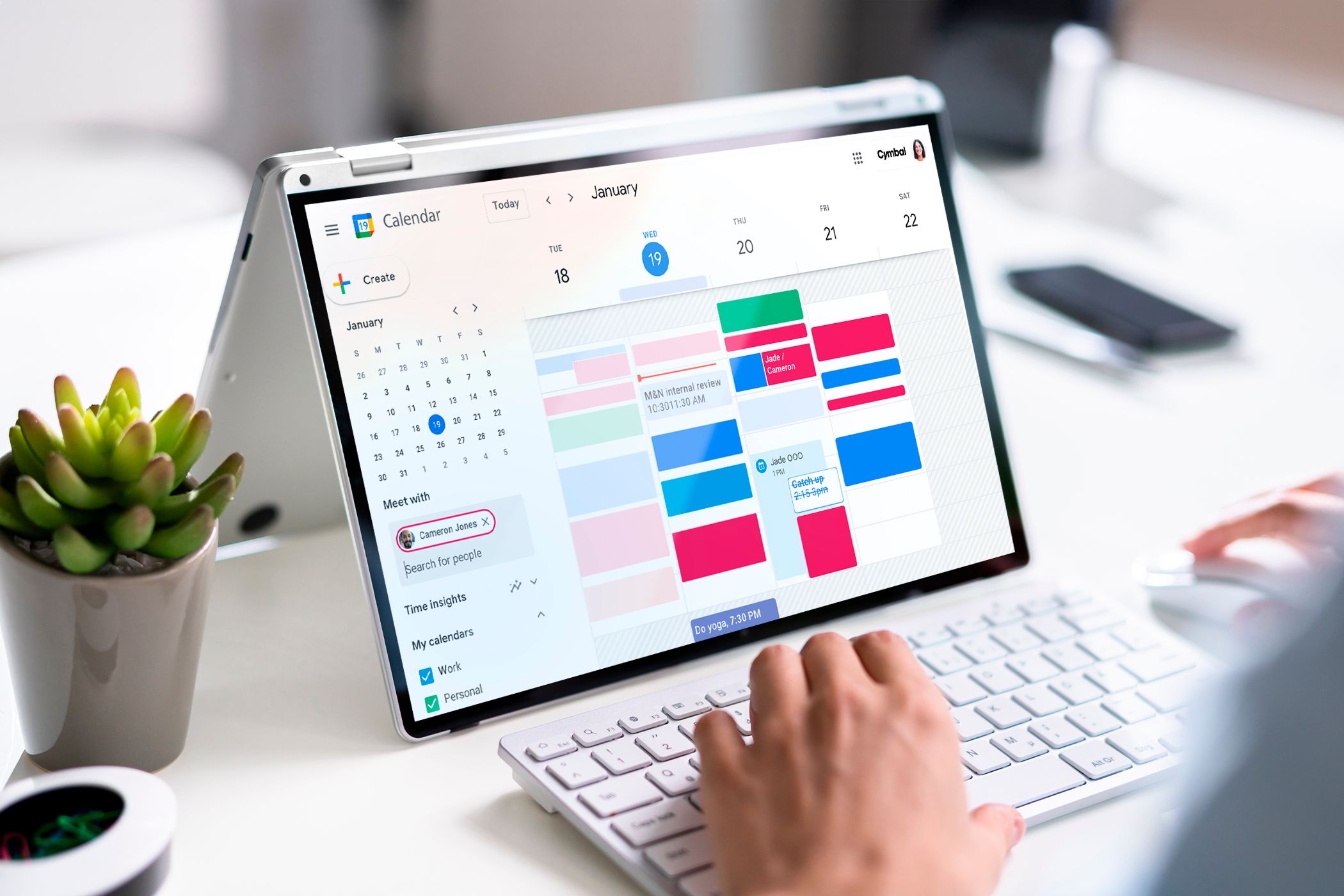 Laptop screen displaying a clutter-free calendar with meetings scheduled.