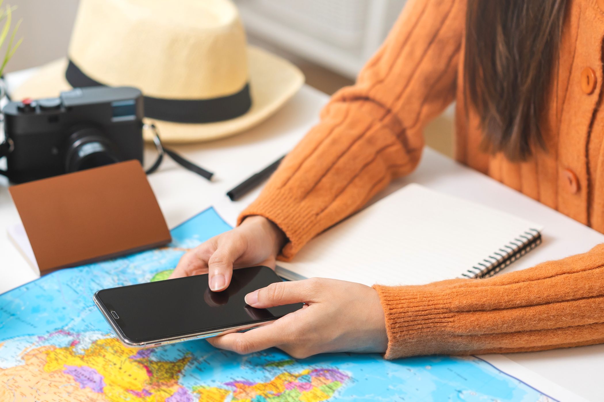 Person using smartphone to plan flight