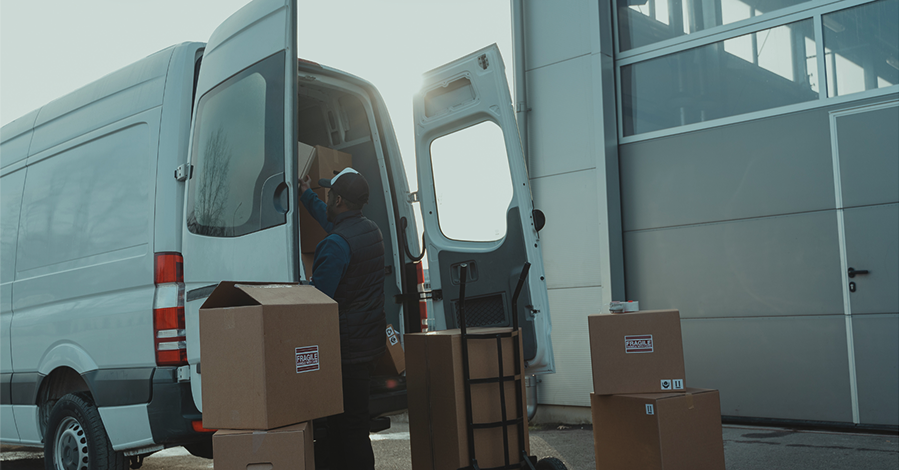 Delivery driver unloading boxes from a truck.