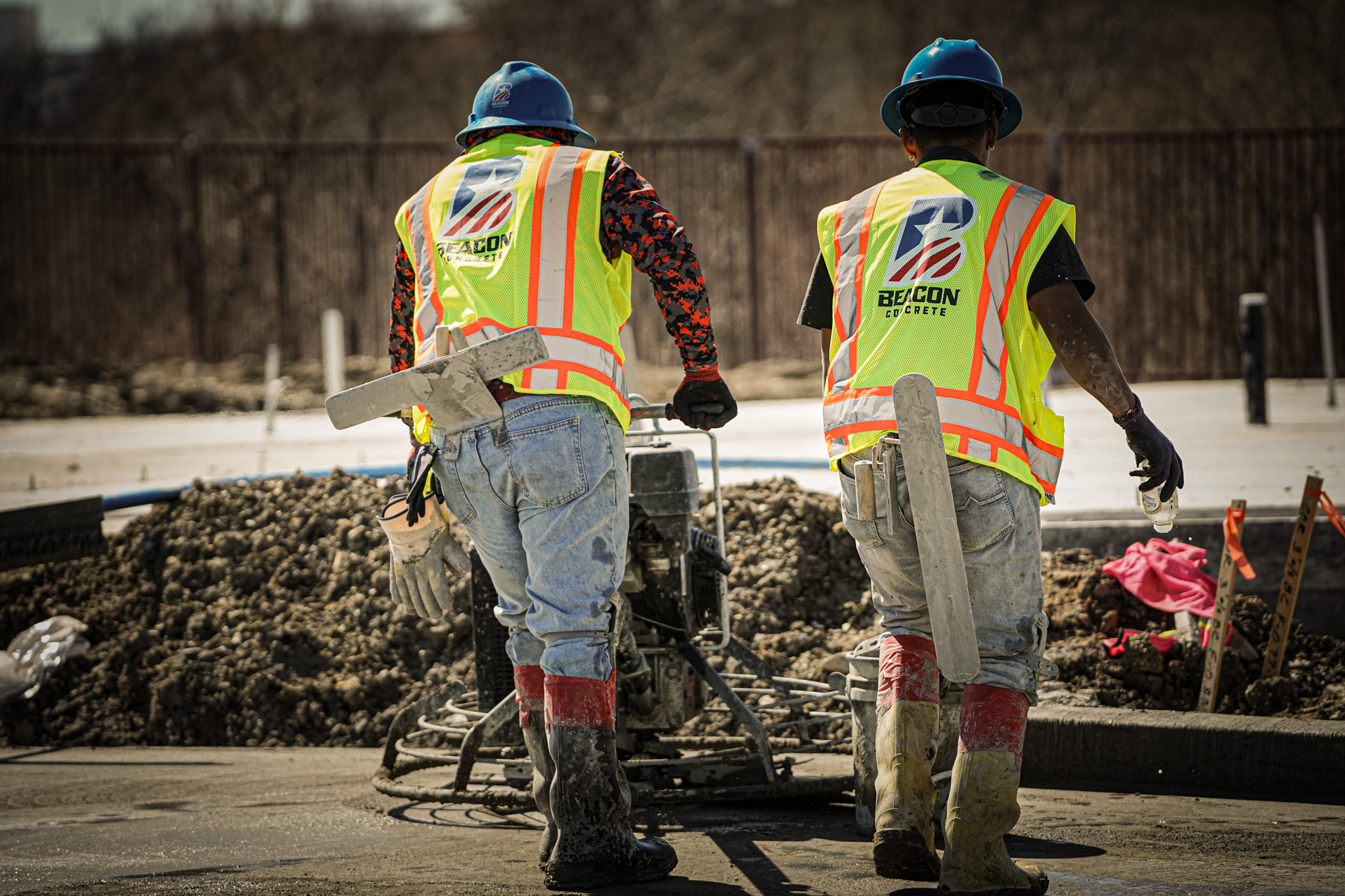 Two men working on concrete site