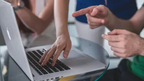 Typing on a laptop