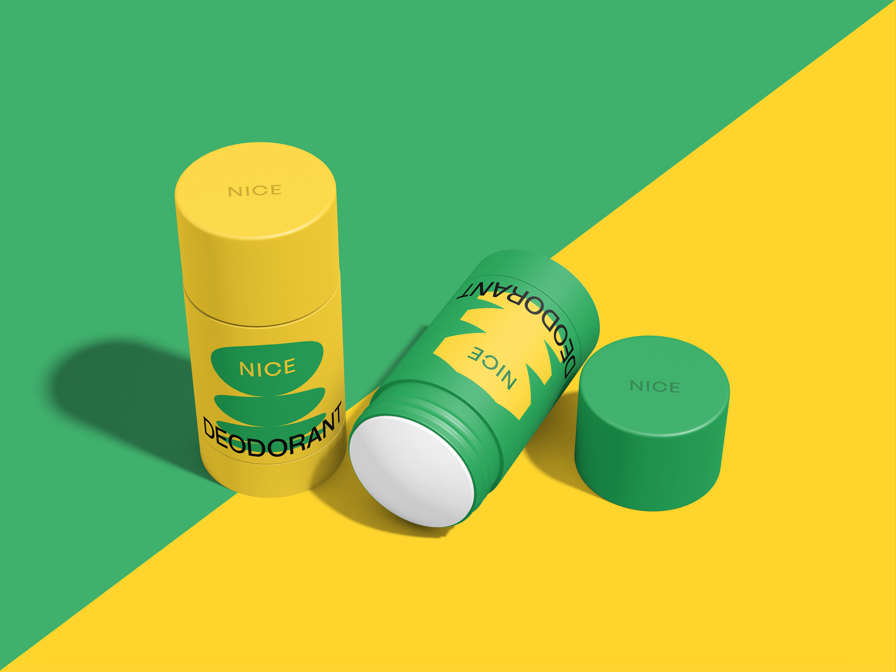 Two deodorant sticks, one yellow upright and one green lying with its green cap beside it, on a diagonally split green and yellow background.