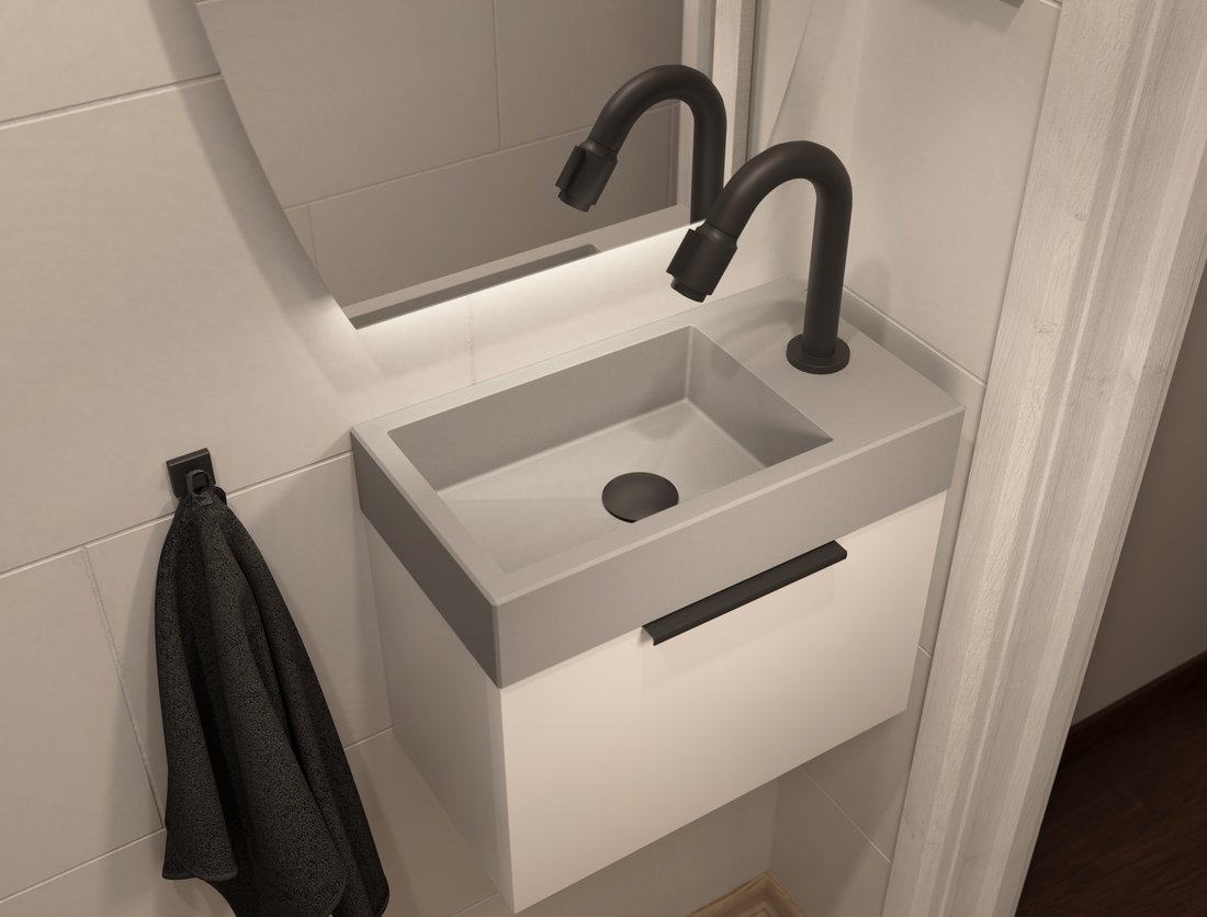 Fonteintje van solid surface op een wit meubel, met een zwarte kraan