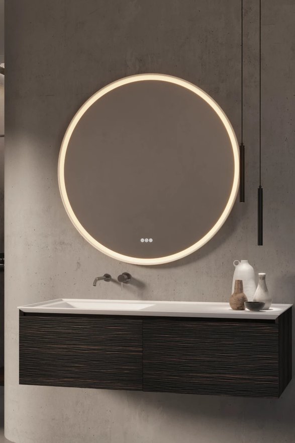 Wastafelmeubel met donker ribbelfront en een wandkraan onder een ronde spiegel met verlichting.