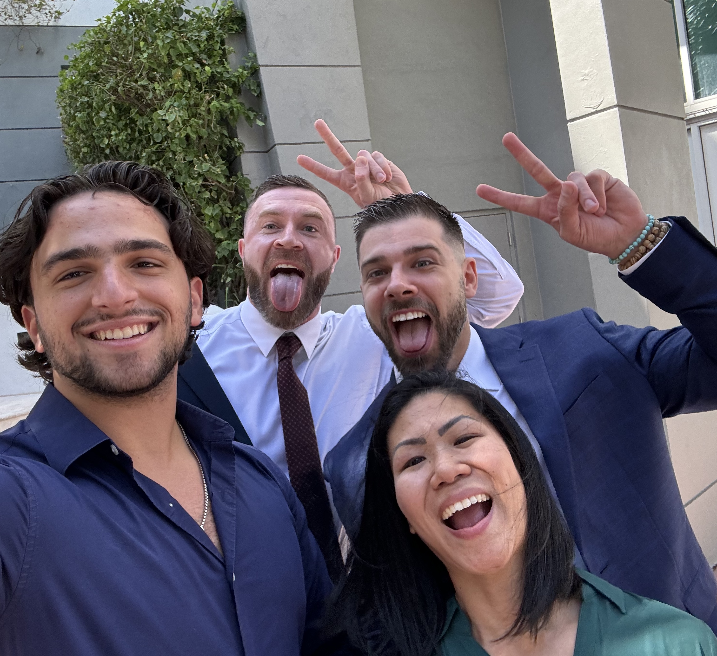 A few Herzfeld Advisors team members smiling and making silly faces.
