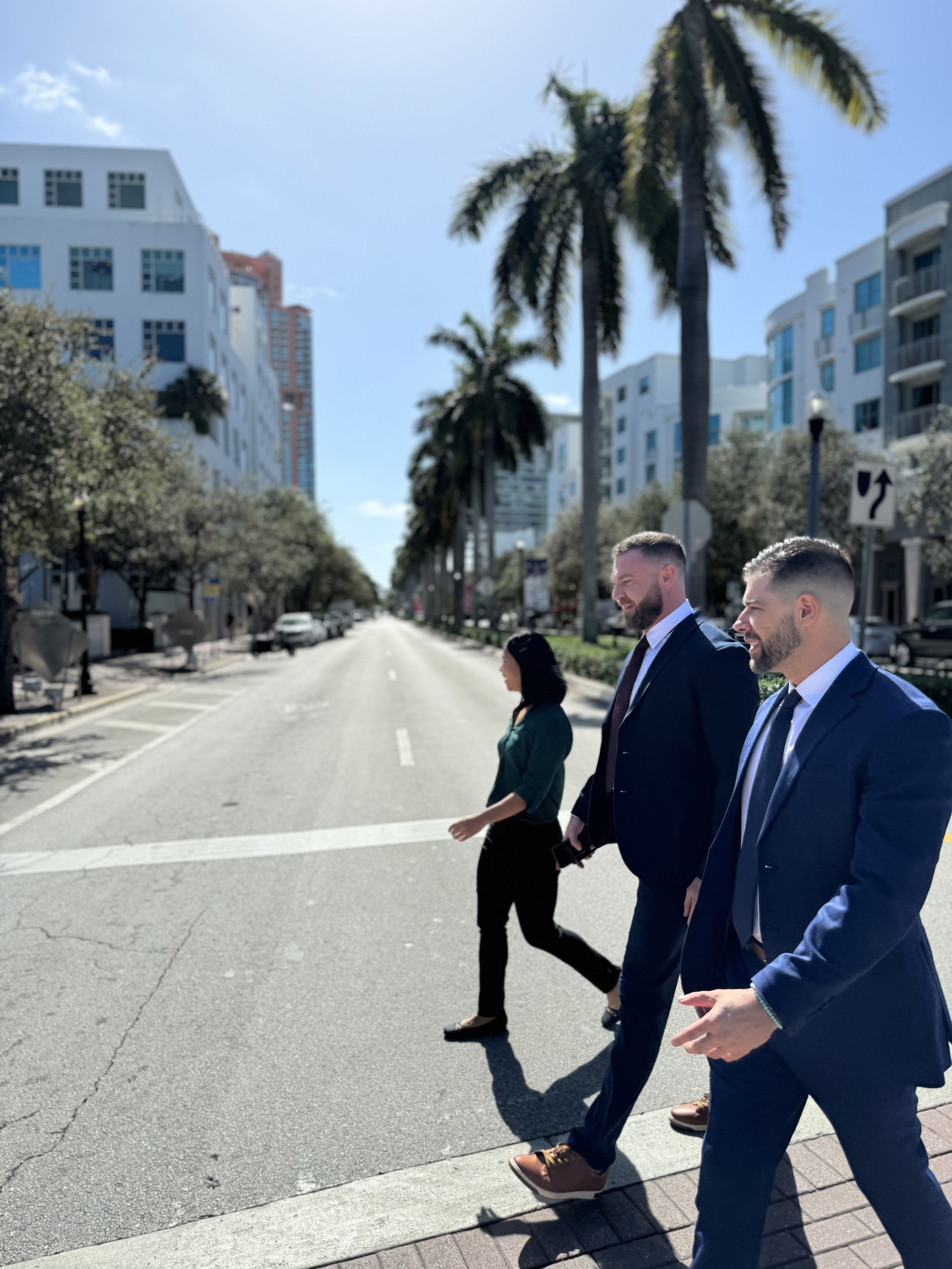 A few Herzfeld Advisors team members smiling and making silly faces.