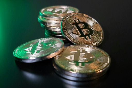 A stack of bitcoins on a black surfaceAI-generated content may be incorrect.