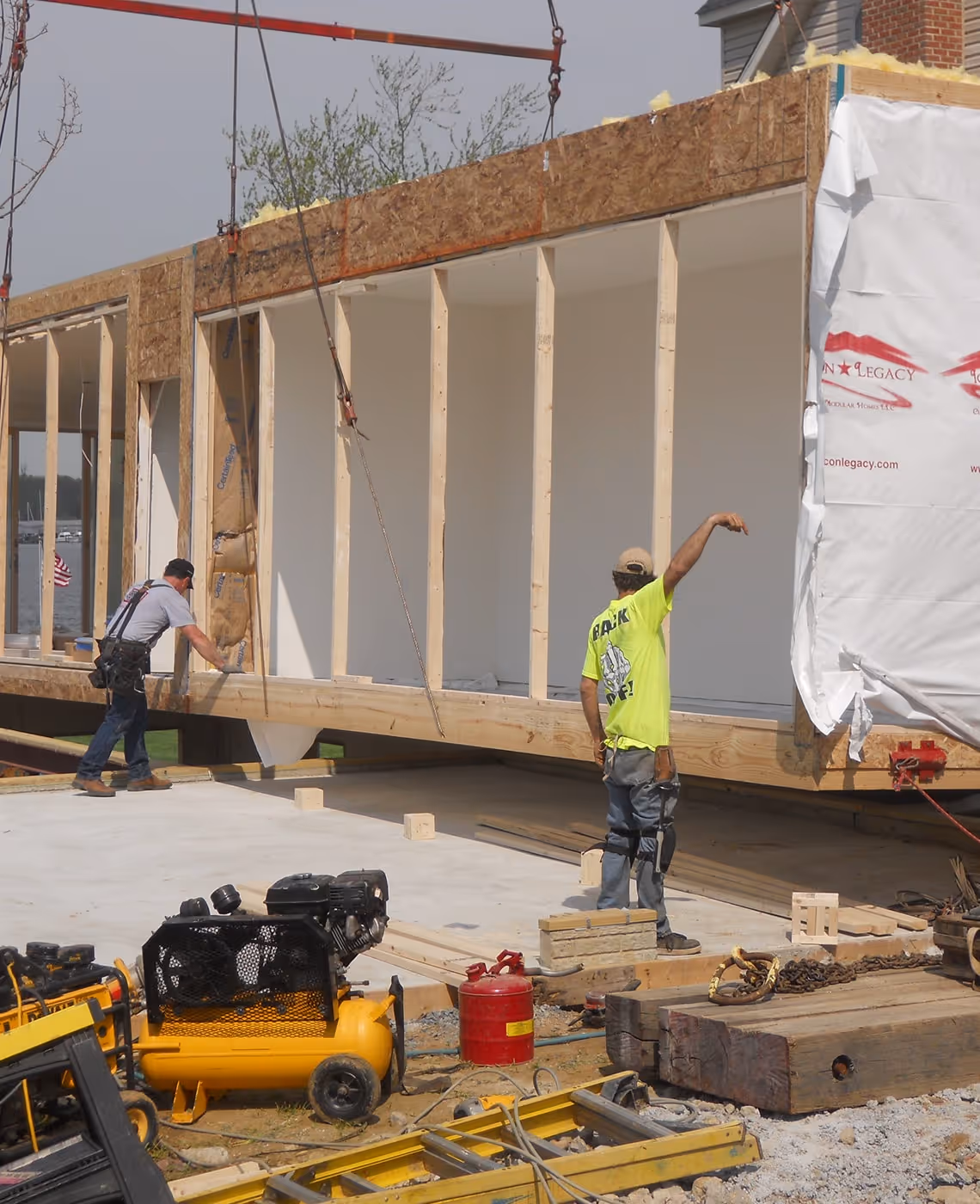 Builders on construction site installing modular home