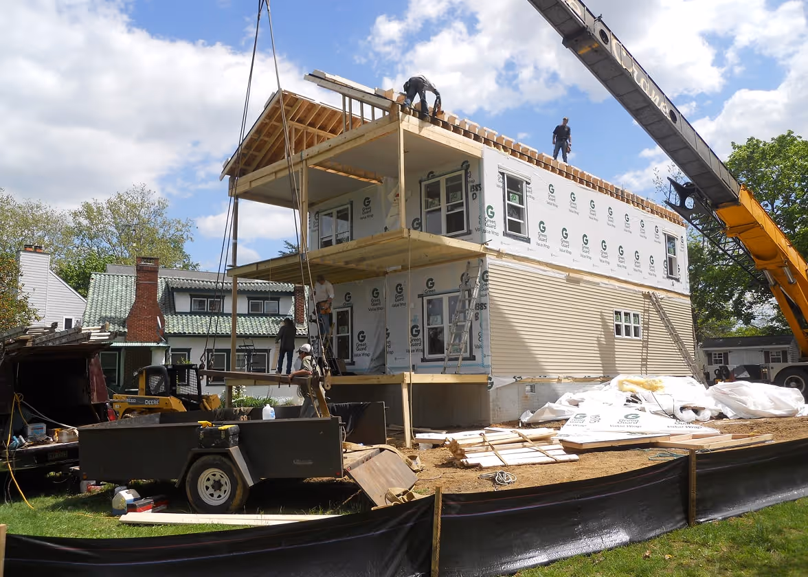 Construction site with crane installing modular home