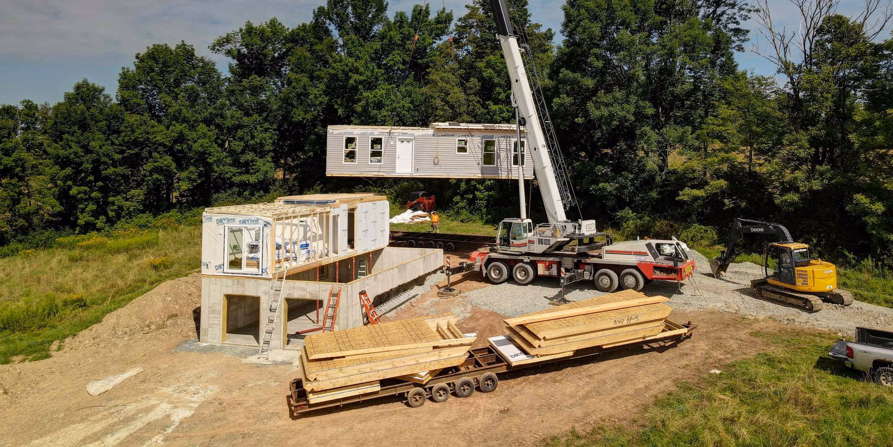 Construction site with crane erecting modular home