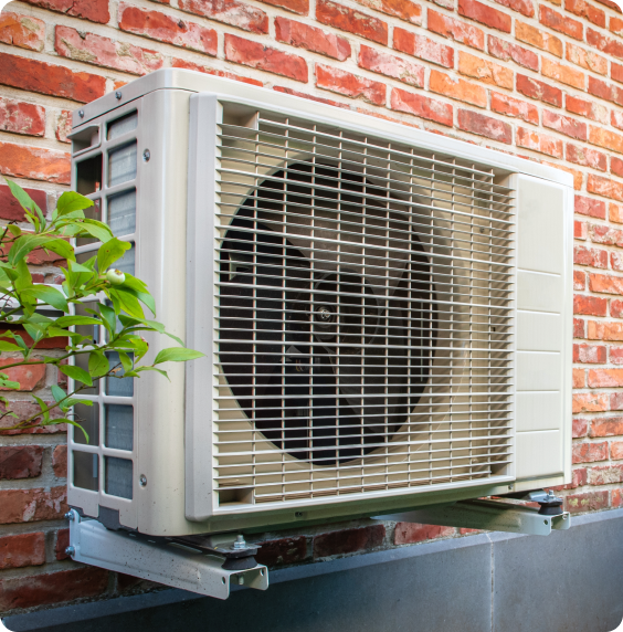 An air source heat pump is mounted on the exterior wall of a classic orange brick UK home, significantly enhancing the household's energy efficiency.