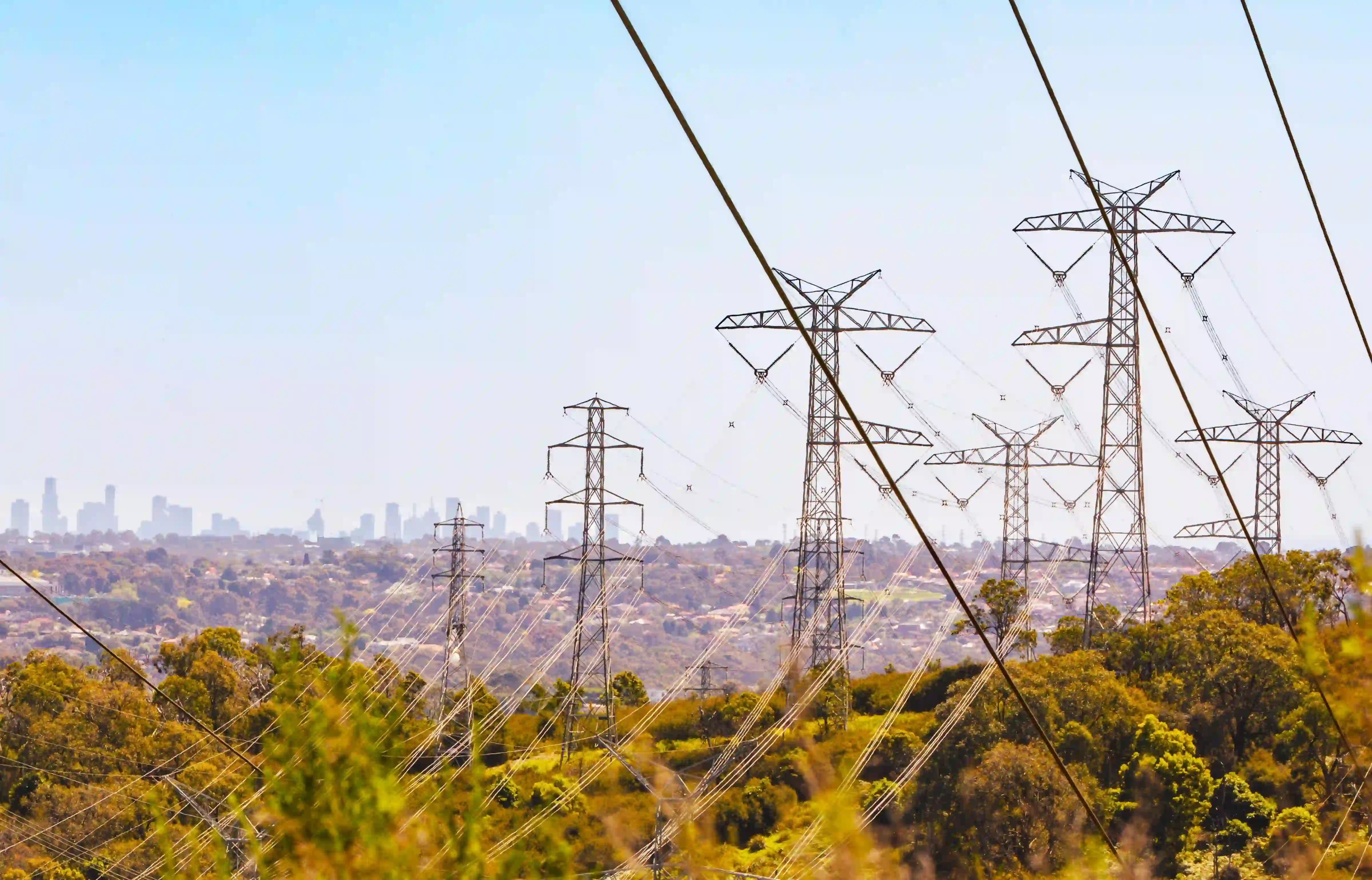 Power lines and towers over cityscape