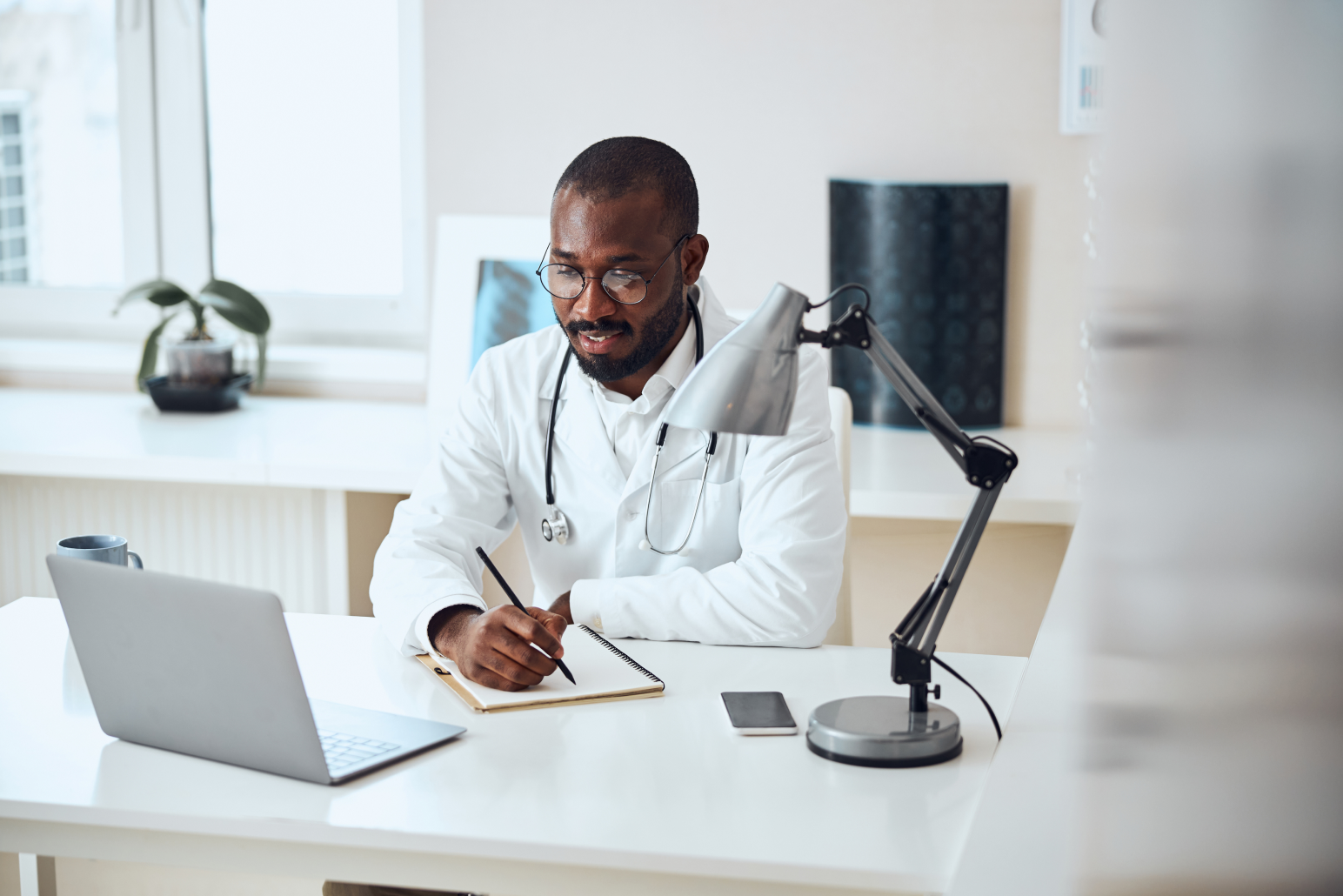 Physician sitting at desk doing research.