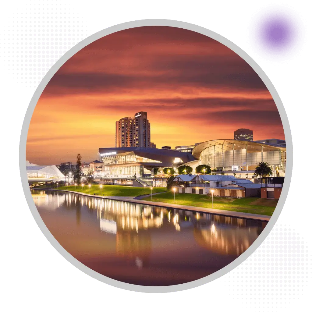 Adelaide city skyline with Adelaide Oval convention centre reflecting in Torrens River at sunset