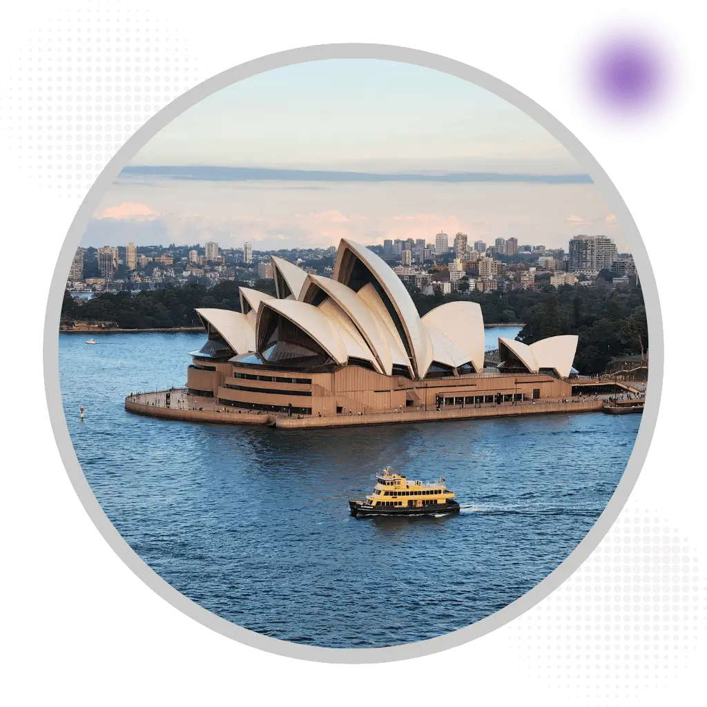 Sydney Opera House on harbor with ferry boat and city skyline in New South Wales