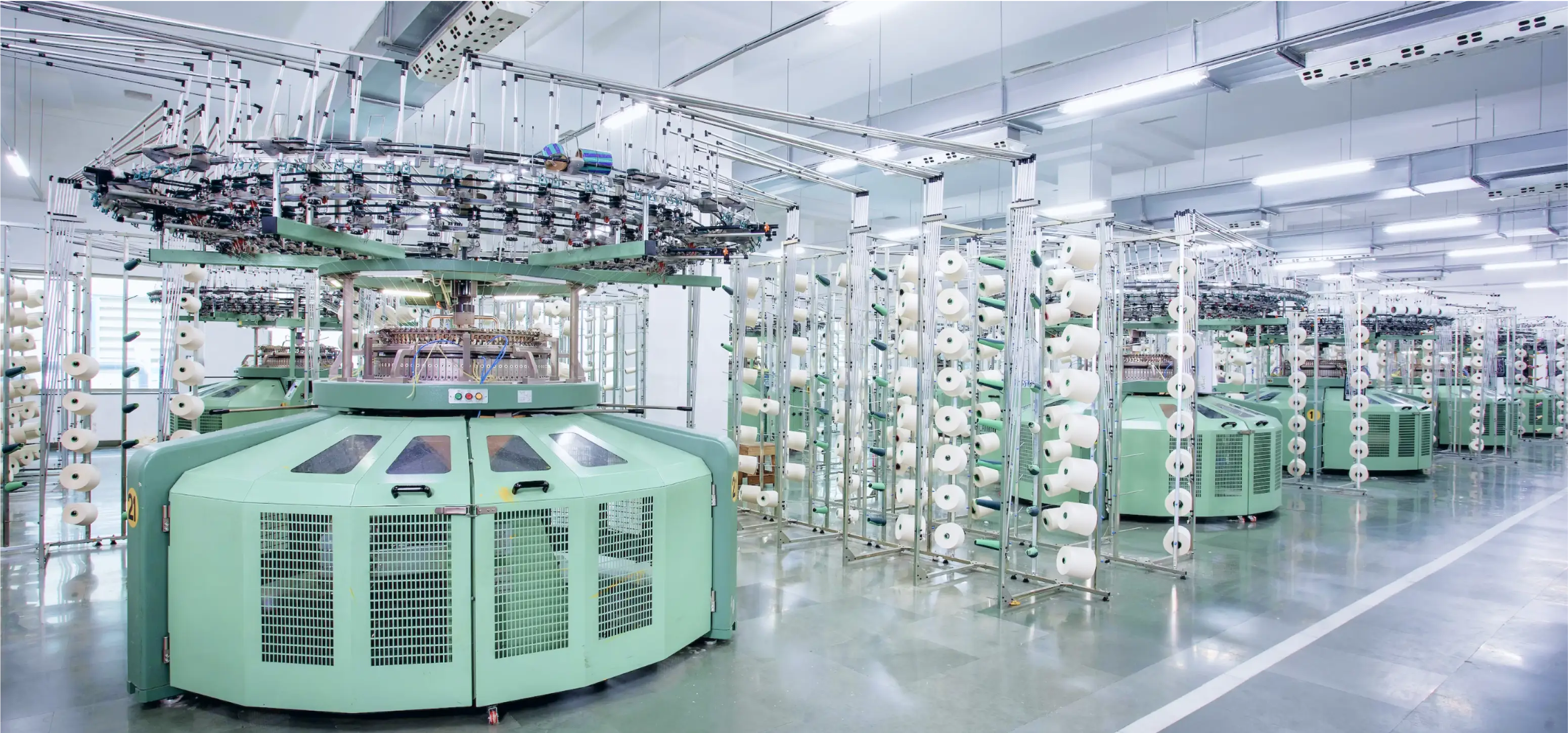 a machine with a lot of rolls of yarn