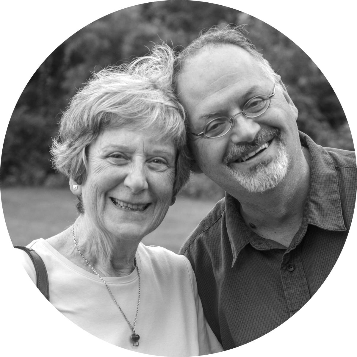 A woman and a man smiling with their heads together