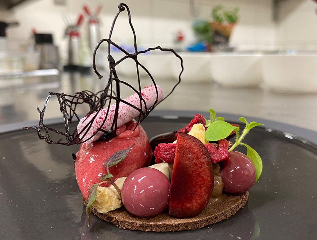 Dinner made in an artsy way. By Arne Linke the chef cook at Café alte Schule by Erna in Wulfshagen, Tüttendorf. We can see beautifully arranged ice cream and fruits in all colors and variations.