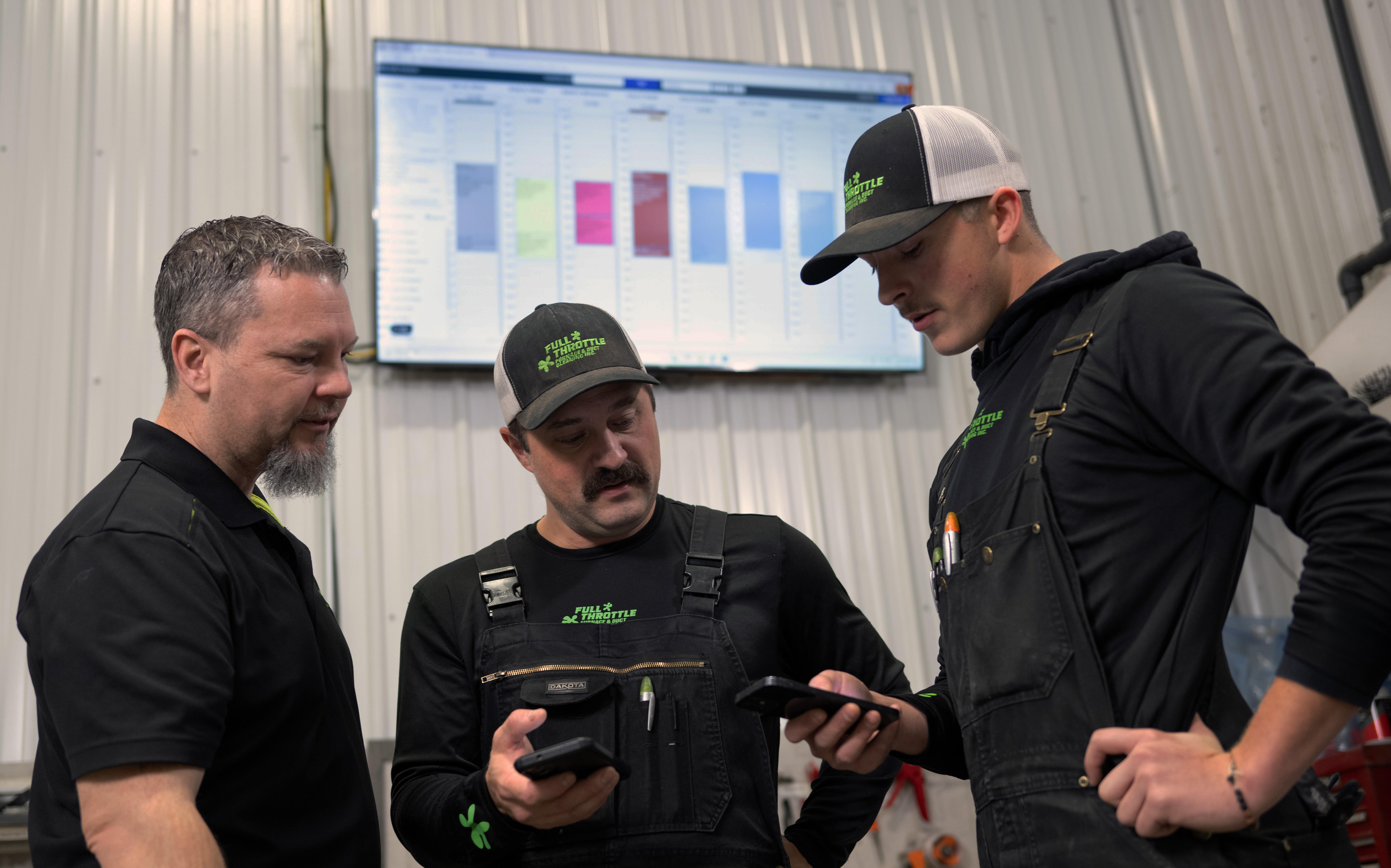 ServiceBox customer team reviewing information together on a mobile phone