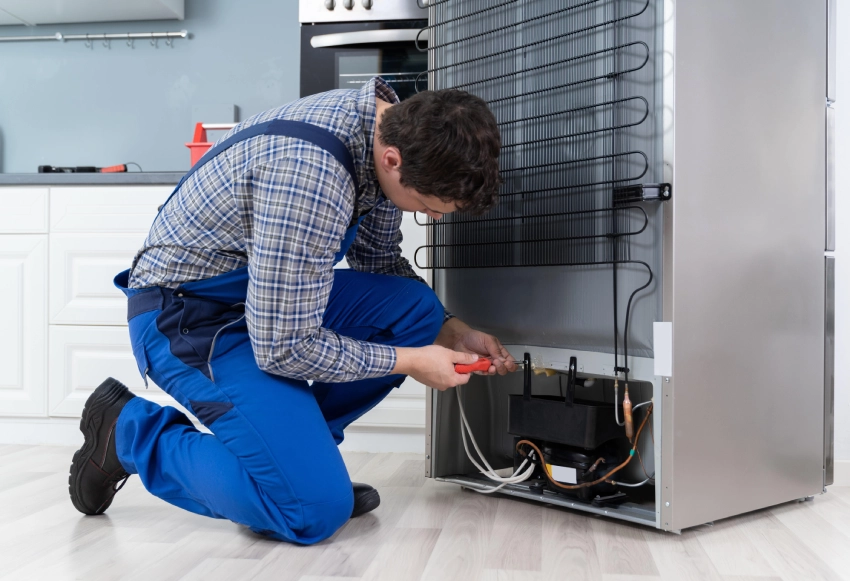 Refrigeration technician servicing commercial cooling equipment