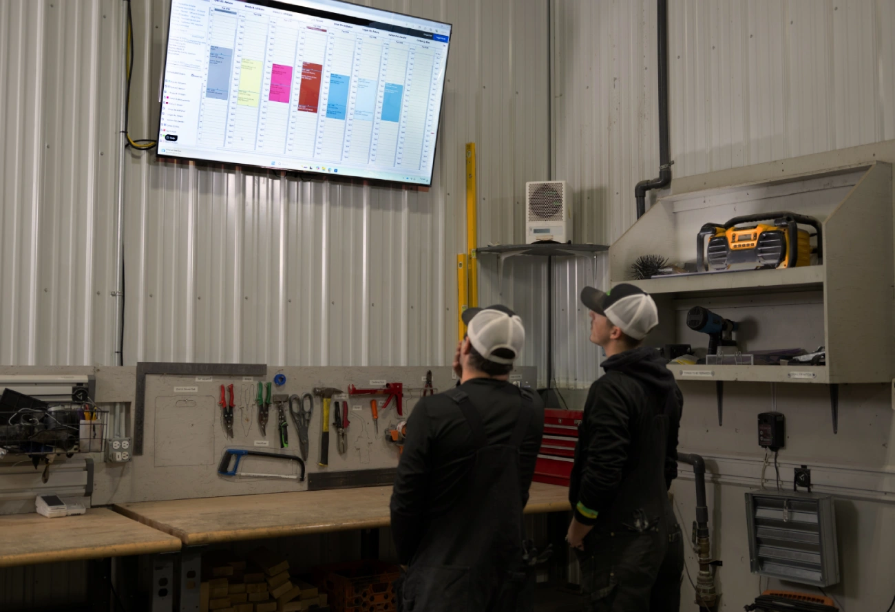 Multi-trade service team reviewing operational work in a workshop.