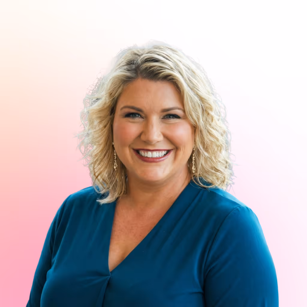 Smiling blonde woman with curly hair wearing a teal V-neck top and gold dangling earrings against a pink and white gradient background.